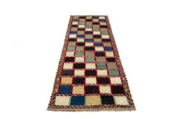 Surface texture of 2000s Persian Gabbeh rug with natural Wool and intricate pattern