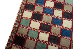 Backside of handmade 2000s Persian Gabbeh rug showing knot structure and weave density