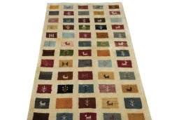 Surface texture of 2000s Persian Gabbeh rug with natural Wool and intricate pattern