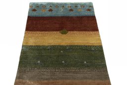 Surface texture of 2000s Persian Gabbeh rug with natural Wool and intricate pattern