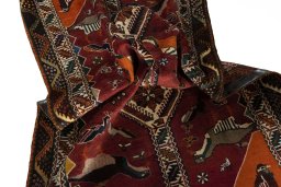 Corner detail of 2000s Persian Gabbeh rug showing border pattern and Wool pile