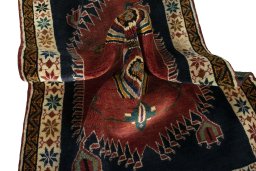 Corner detail of 2000s Persian Gabbeh rug showing border pattern and Wool pile