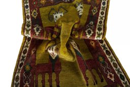 Corner detail of 2000s Persian Gabbeh rug showing border pattern and Wool pile