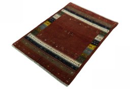 Corner detail of 2000s Persian Gabbeh rug showing border pattern and Wool pile