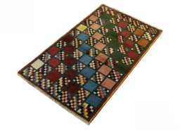 Corner detail of 2000s Persian Gabbeh rug showing border pattern and Wool pile