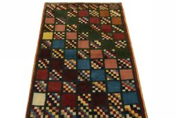Surface texture of 2000s Persian Gabbeh rug with natural Wool and intricate pattern