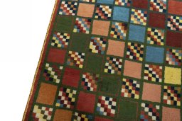 Backside of handmade 2000s Persian Gabbeh rug showing knot structure and weave density