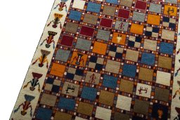 Backside of handmade 2000s Persian Gabbeh rug showing knot structure and weave density