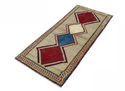Corner detail of 2000s Persian Gabbeh rug showing border pattern and Wool pile