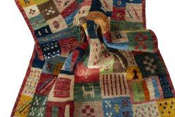 Corner detail of 2000s Persian Gabbeh rug showing border pattern and Wool pile