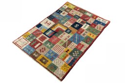 Corner detail of 2000s Persian Gabbeh rug showing border pattern and Wool pile