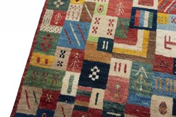 Backside of handmade 2000s Persian Gabbeh rug showing knot structure and weave density