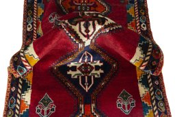 Corner detail of 2000s Persian Gabbeh rug showing border pattern and Wool pile