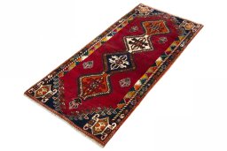 Corner detail of 2000s Persian Gabbeh rug showing border pattern and Wool pile