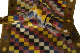 Corner detail of 2000s Persian Gabbeh rug showing border pattern and Wool pile