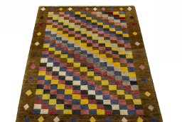 Surface texture of 2000s Persian Gabbeh rug with natural Wool and intricate pattern