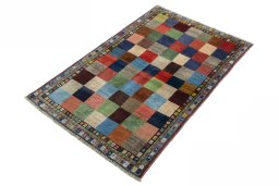 Corner detail of 2000s Persian Gabbeh rug showing border pattern and Wool pile