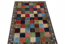 Surface texture of 2000s Persian Gabbeh rug with natural Wool and intricate pattern
