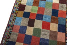 Backside of handmade 2000s Persian Gabbeh rug showing knot structure and weave density