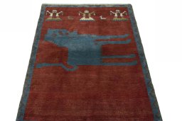 Surface texture of 2000s Persian Gabbeh rug with natural Wool and intricate pattern