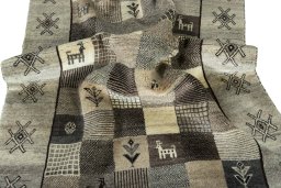 Corner detail of 2000s Persian Gabbeh rug showing border pattern and Wool pile
