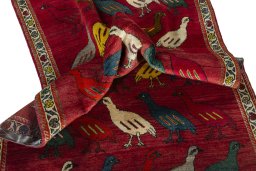 Corner detail of 2000s Persian Gabbeh rug showing border pattern and Wool pile