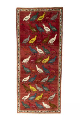 Full view of 2000s Persian Gabbeh rug from Iran / Persia, 296 × 127 cm in Red tones