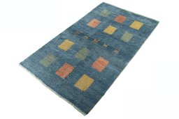 Corner detail of 2000s Persian Gabbeh rug showing border pattern and Wool pile