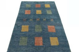 Surface texture of 2000s Persian Gabbeh rug with natural Wool and intricate pattern