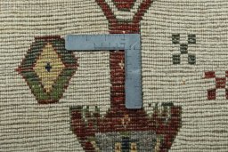 Corner detail of 2000s Persian Gabbeh rug showing border pattern and Wool pile