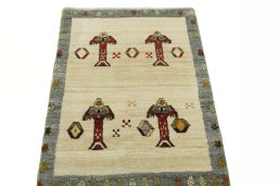 Surface texture of 2000s Persian Gabbeh rug with natural Wool and intricate pattern