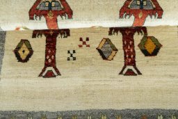Full view of 2000s Persian Gabbeh rug from Iran / Persia, 117 × 81 cm in Beige tones