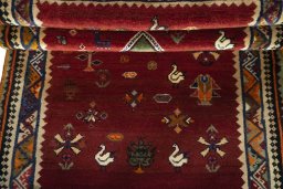 Corner detail of 2000s Persian Gabbeh rug showing border pattern and Wool pile