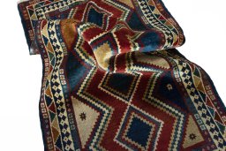 Corner detail of 2000s Persian Gabbeh rug showing border pattern and Wool pile