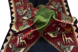Corner detail of 2000s Persian Gabbeh rug showing border pattern and Wool pile