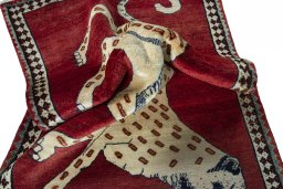 Corner detail of 2000s Persian Gabbeh rug showing border pattern and Wool pile