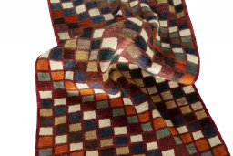 Corner detail of 2000s Persian Gabbeh rug showing border pattern and Wool pile