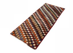 Corner detail of 2000s Persian Gabbeh rug showing border pattern and Wool pile