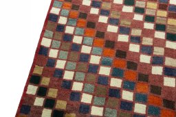 Backside of handmade 2000s Persian Gabbeh rug showing knot structure and weave density