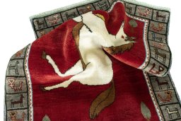 Corner detail of 2000s Persian Gabbeh rug showing border pattern and Wool pile