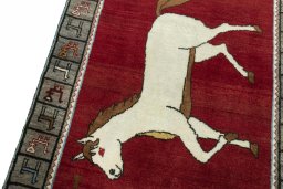 Backside of handmade 2000s Persian Gabbeh rug showing knot structure and weave density