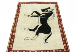 Surface texture of 2000s Persian Gabbeh rug with natural Wool and intricate pattern