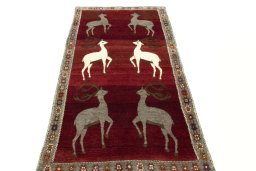 Surface texture of 2000s Persian Gabbeh rug with natural Wool and intricate pattern