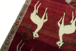 Backside of handmade 2000s Persian Gabbeh rug showing knot structure and weave density