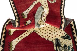 Corner detail of 2000s Persian Gabbeh rug showing border pattern and Wool pile