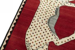 Backside of handmade 2000s Persian Gabbeh rug showing knot structure and weave density