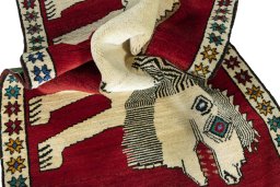 Corner detail of 2000s Persian Gabbeh rug showing border pattern and Wool pile