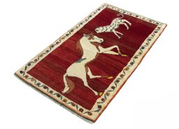 Corner detail of 2000s Persian Gabbeh rug showing border pattern and Wool pile