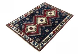 Corner detail of 2000s Persian Gabbeh rug showing border pattern and Wool pile