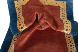 Corner detail of 2000s Persian Gabbeh rug showing border pattern and Wool pile